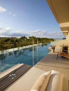a swimming pool with a view of the ocean at Asterion Suites & Spa - Designed for Adults in Gerani