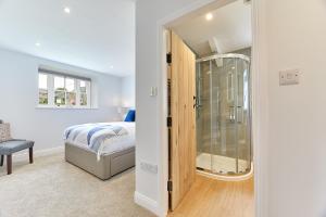 a bedroom with a bed and a glass shower at Host & Stay - Maggie's in Chesters +6 photos