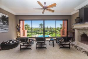 a living room with chairs and a fireplace at La Villa Rose Anna in Marrakesh