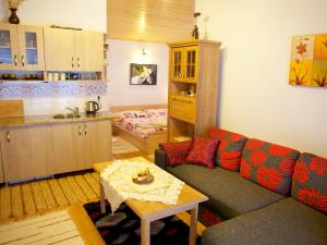 a living room with a couch and a kitchen at Apartmany Agnes dedina Zuberec 248 in Zuberec