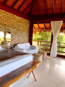 um quarto com 2 camas e uma parede de tijolos em Ecolodge Praia de Gravatá - Pernambuco- Brasil em São José da Coroa Grande