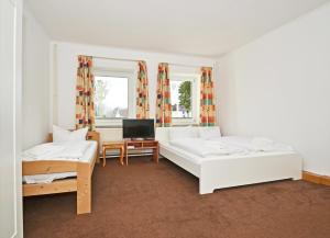 Кровать или кровати в номере Ferienanlage Zempin Haus Achterwasser