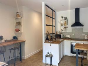 a kitchen with white cabinets and a counter top at Maison Farol in Salles