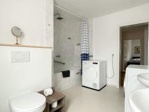 ein weißes Bad mit einem WC und einem Waschbecken in der Unterkunft Apartment Fuchsbau in Senftenberg