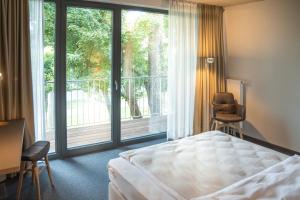 Una cama o camas en una habitación de Hotel Annenhof GmbH