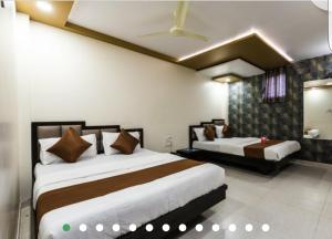 Postel nebo postele na pokoji v ubytování Hotel Guestinn Residency