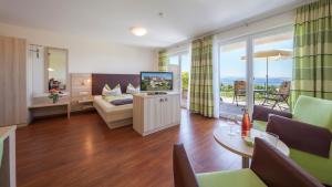 a living room with a tv and a couch and a table at Sonnenhof Hagnau in Hagnau