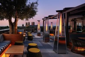 a rooftop patio with tables and chairs and a tree at Malmaison York in York