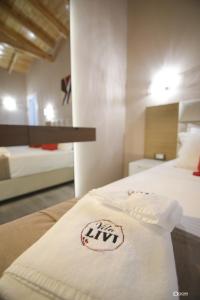 a bedroom with a bed with a white blanket on it at Vila Livi in Korçë