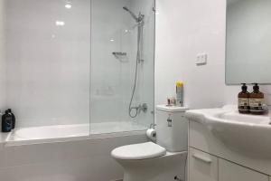 a white bathroom with a shower and a toilet and a sink at Liverpool holiday apartment 2Bedroom 2Bathroom in Liverpool