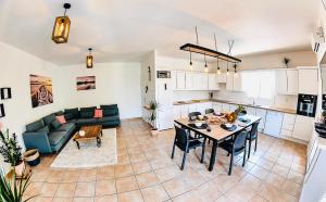 a kitchen and living room with a table and a couch at spacieux T5, terrasse, proche centre,parking privé in Perpignan +11 photos