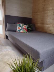 a bed with two pillows on it in a room at Villa Solina in Zawóz