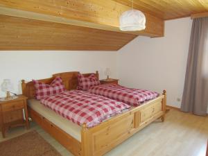 a bedroom with a bed with red and white pillows at Mesnerhof in Bayerbach