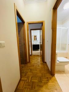 a hallway with a bathroom and a toilet in a room at Apartamento Rey Daviña in Vilagarcia de Arousa