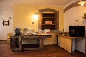 a kitchen with a counter and a table in a room at Agriturismo Cascina Costa in Cassago Brianza