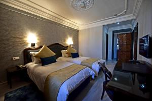 非斯的住宿－Hôtel Fès Inn & SPA，酒店客房设有两张床和电视。