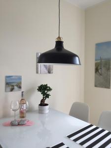 een zwart hangerlicht boven een witte tafel bij Ferienwohnung Schauf 2 in Dahme