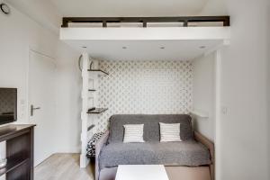 a bedroom with a loft bed with a couch at Le Black and White - Trianon in Versailles
