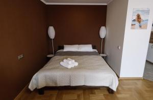 a bedroom with a bed with a white towel on it at Тиха та комфортна квартира in Ternopilʼ