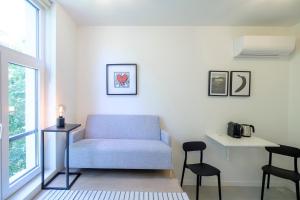 a living room with a couch and a table at Studios with city view in Brussels