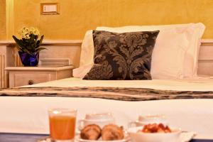 a bed with a pillow and a tray of food at Hotel Al Piave in Venice