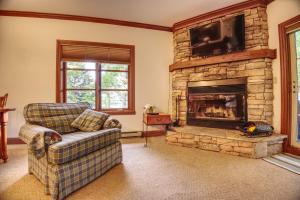a living room with a couch and a fireplace at Le Plateau by Rendez-Vous Mont-Tremblant in Mont-Tremblant