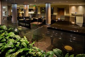 a restaurant with tables and plants in a building at Windsor Hotel in Córdoba