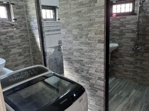 a bathroom with a shower and a toaster at Bungalow at Pereybere in Grand-Baie +46 photos