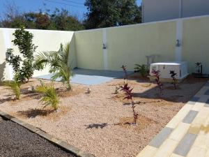 a garden with plants in front of a building at Bungalow at Pereybere in Grand-Baie