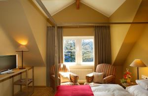 a hotel room with a bed and a window at Schloss Eberstein in Gernsbach