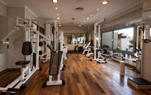a gym with treadmills and machines in a room at Windsor Hotel in Córdoba
