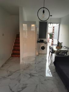 a living room with a marble floor and a dining room at EROS Maisonette in Latchi area just 700 meters or one-minute drive from Polis Municipal Beach in Lachi