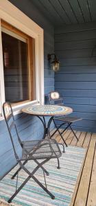 a table and chairs sitting on a porch at Rukan HonkaLempi in Ruka +7 photos
