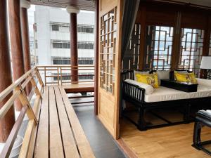 a balcony with a bench in a room at The Lantern Hatyai Hotel in Hat Yai