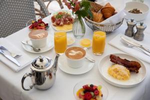 a table topped with plates of breakfast foods and drinks at Hotel Diplomat Stockholm in Stockholm