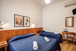 Säng eller sängar i ett rum på Hotel Nuova Italia