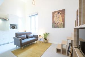 a living room with a chair and a television at Studios with city view in Brussels