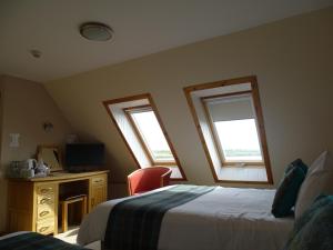a bedroom with a bed and a window at The Sands Hotel, Orkney in Burray Village