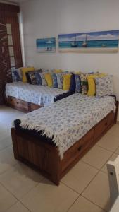 two twin beds in a room with the ocean at Praia do Forte Kauai Bahia in Praia do Forte +31 photos