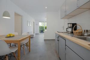 a kitchen with a table and a counter top at Baltic Center Bungalows in Sarbinowo