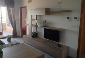 a living room with a flat screen tv on a wall at Fantastic apartment in Torrevieja