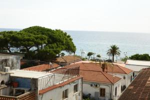 a view of roofs of houses and the ocean at Emerella Luxury Suites-Siderno Lungomare in Siderno Marina