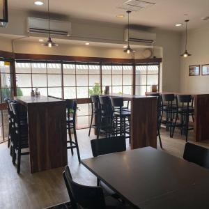 a restaurant with tables and chairs in a room with windows at The Miners Rest Motel in Kalgoorlie