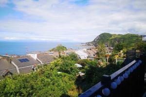 a view from a balcony of a town and the ocean at Large House, sleeps 10 with incredible sea views in Ilfracombe