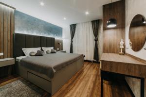 a bedroom with a large bed and a fireplace at Apartman Stari Toranj in Vukovar