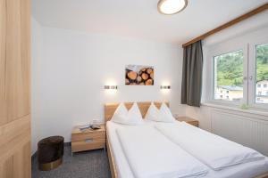 Łóżko lub łóżka w pokoju w obiekcie Appartements Insieme