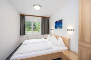 Posteľ alebo postele v izbe v ubytovaní Appartements Insieme