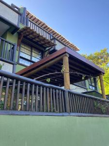 Un balcón de una casa con barandilla de madera. en Praia do Forte Kauai Bahia, en Praia do Forte 25 fotos más