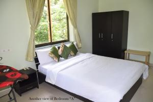 Кровать или кровати в номере Mango Apartment @ Palolem Garden Estate