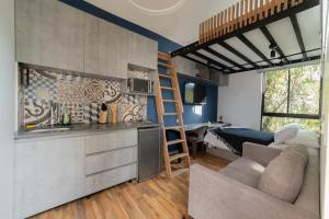 a kitchen and living room with a loft conversion at Alojamiento en tiny house en el Poblado MDE A106 By Roots Rentals in Medellín
